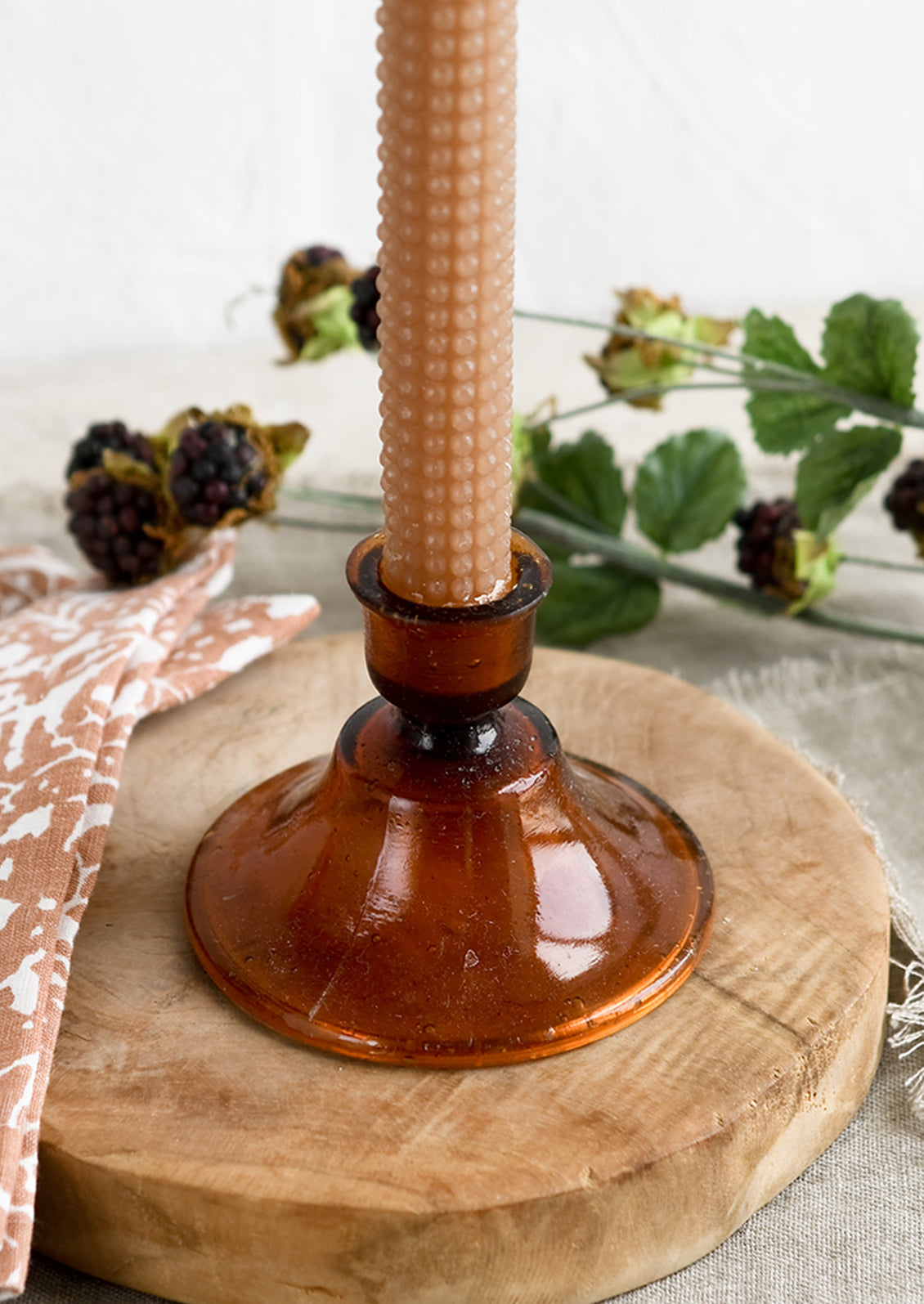 A Moroccan inspired glass taper holder in amber color.