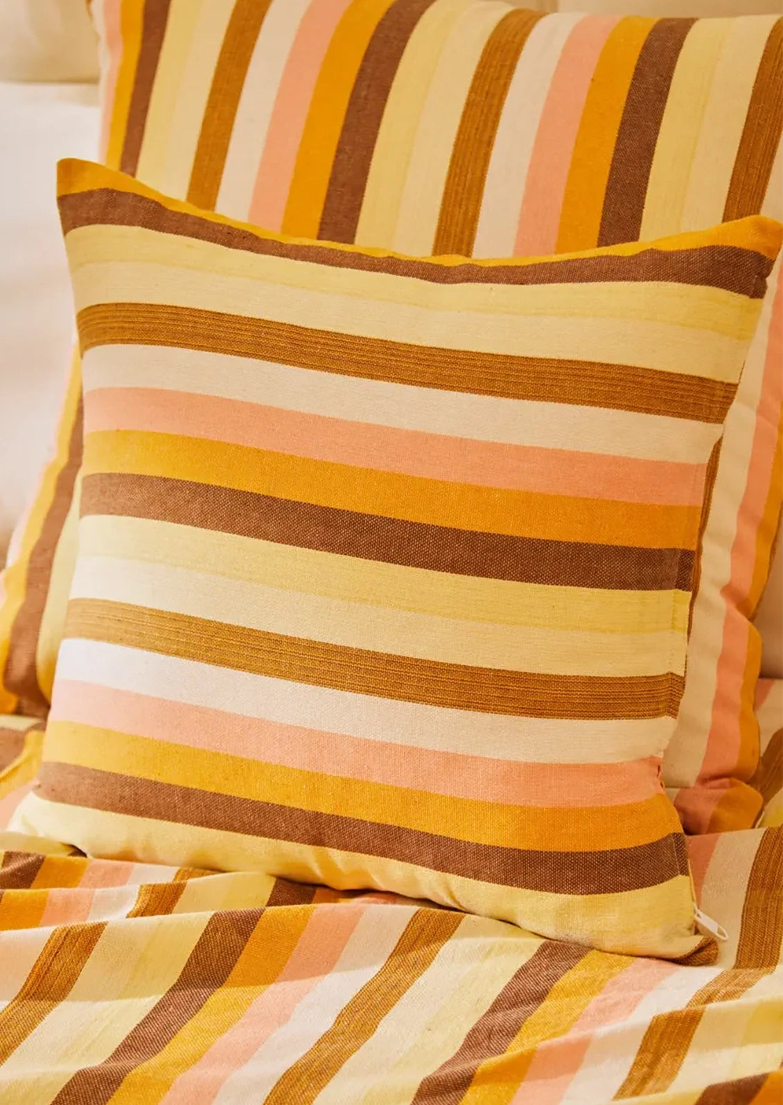 Striped pillow with warm colors.