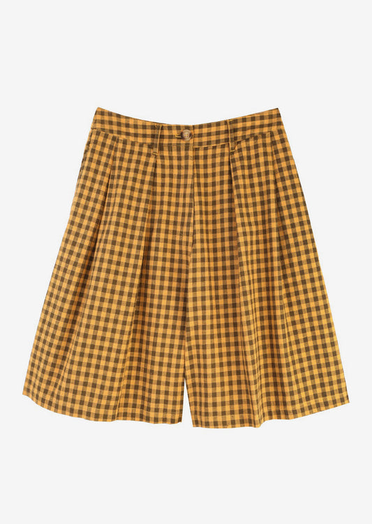 A pair of long, pleat front shorts in brown and mustard gingham.
