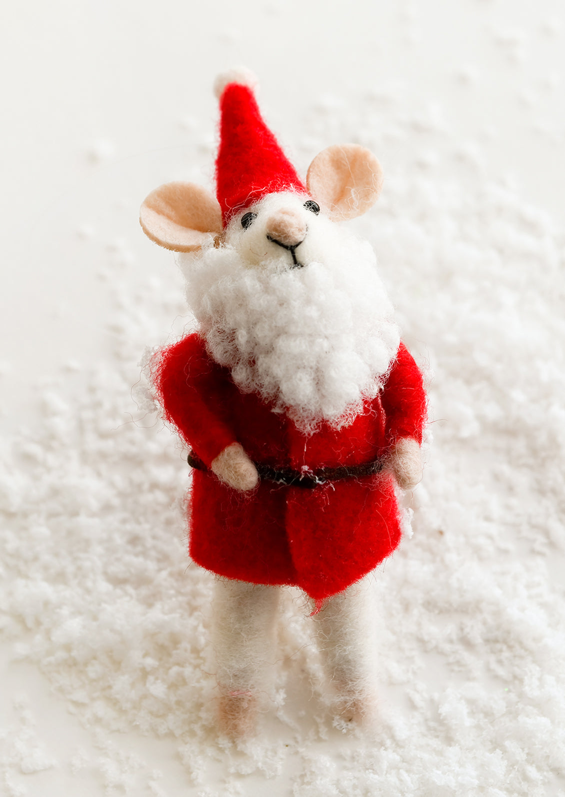 A felted mouse ornament dressed up as Santa.