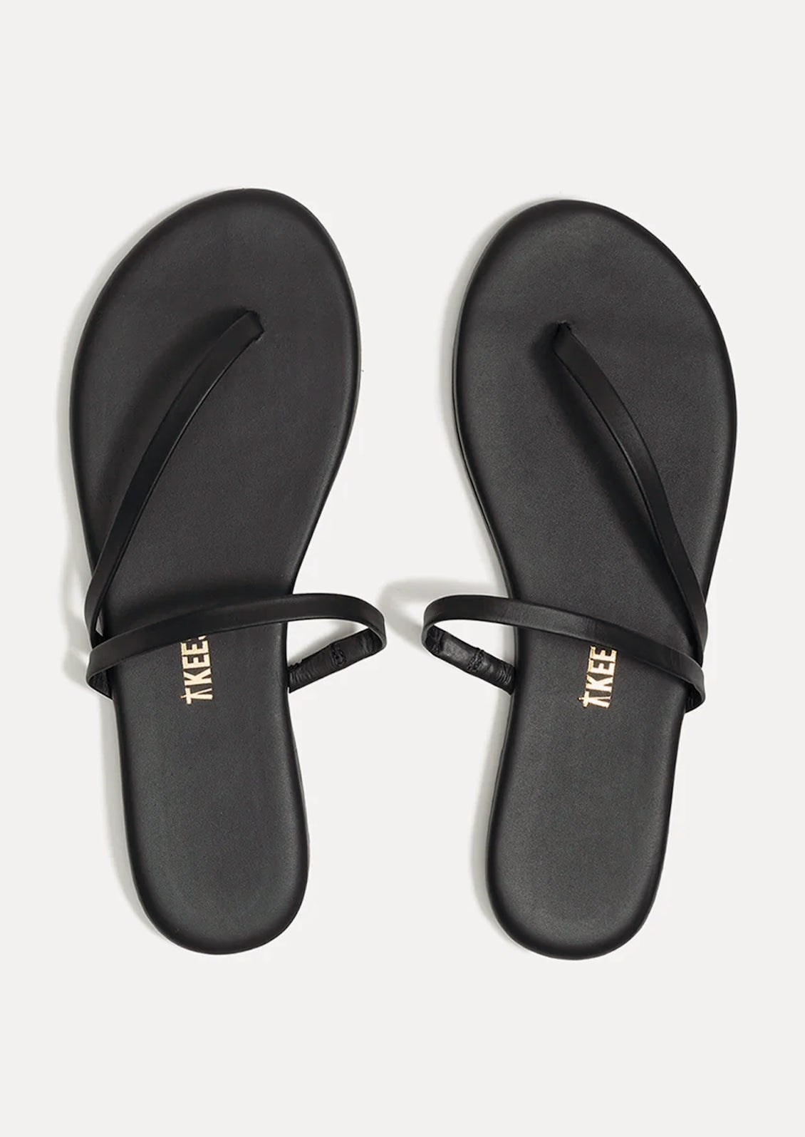 A pair of black leather strappy sandals by TKEES.