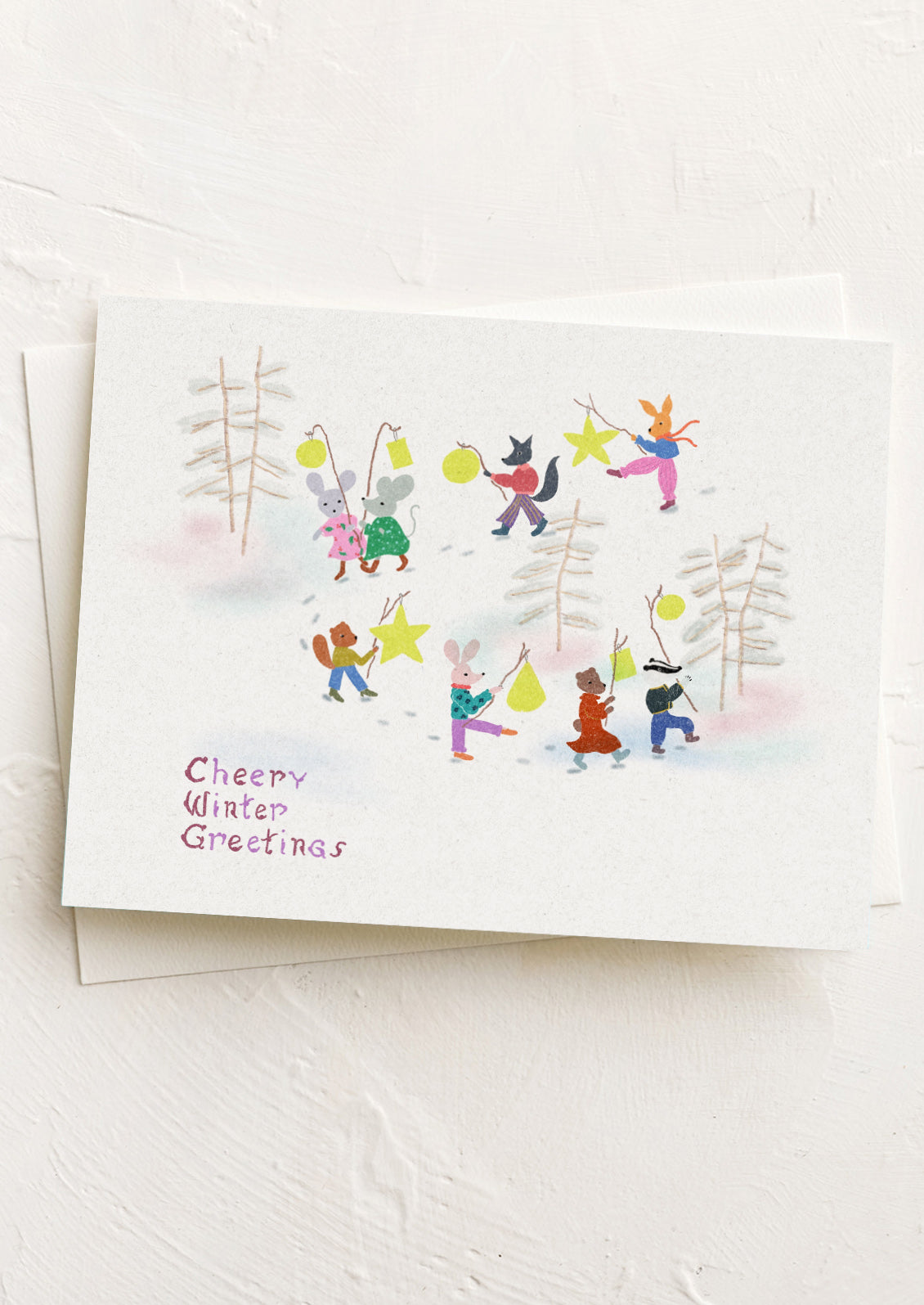 A greeting card with illustration of animals in a winter setting parade holding yellow lanterns.