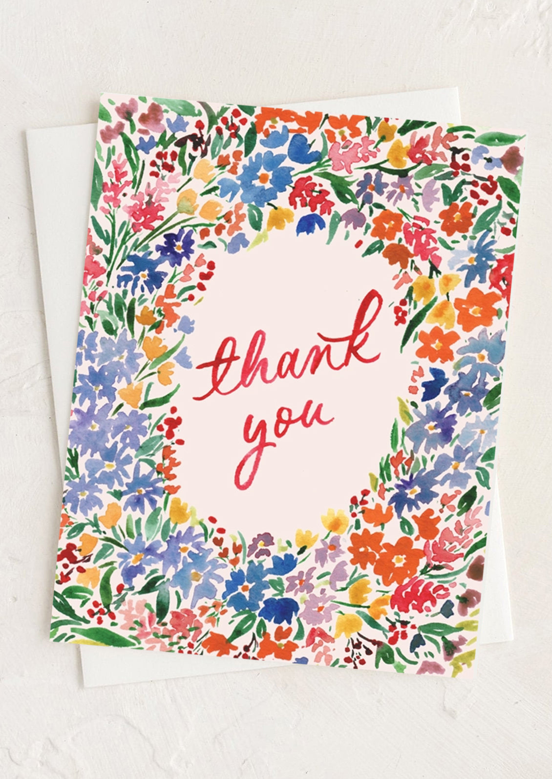 A multicolor floral print card with "thank you" text at center.