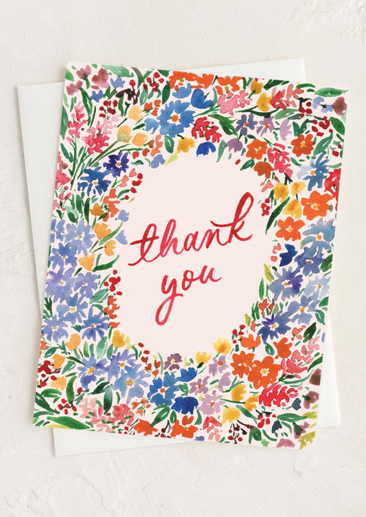 A multicolor floral print card with "thank you" text at center.