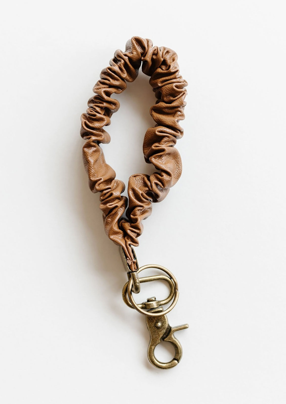 A brown leather scrunchie keychain.