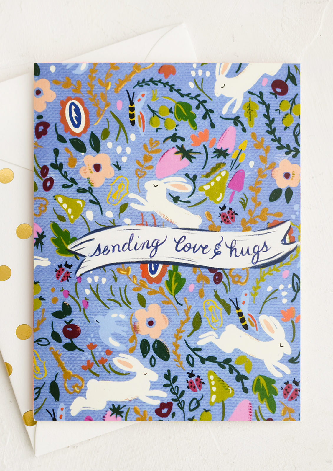A bunny print card reading sending love & hugs.