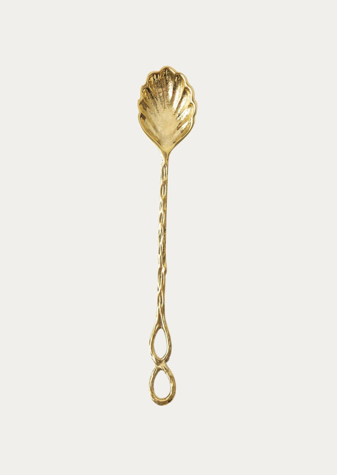 A brass spoon in shell shape.