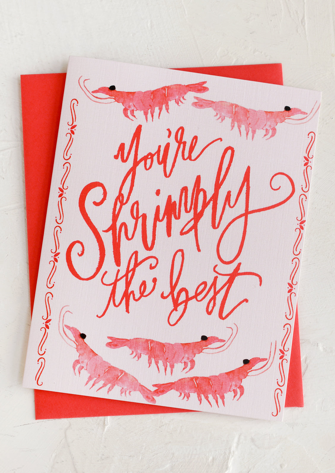 A greeting card with images of shrimp reading "You're Shrimply The Best".