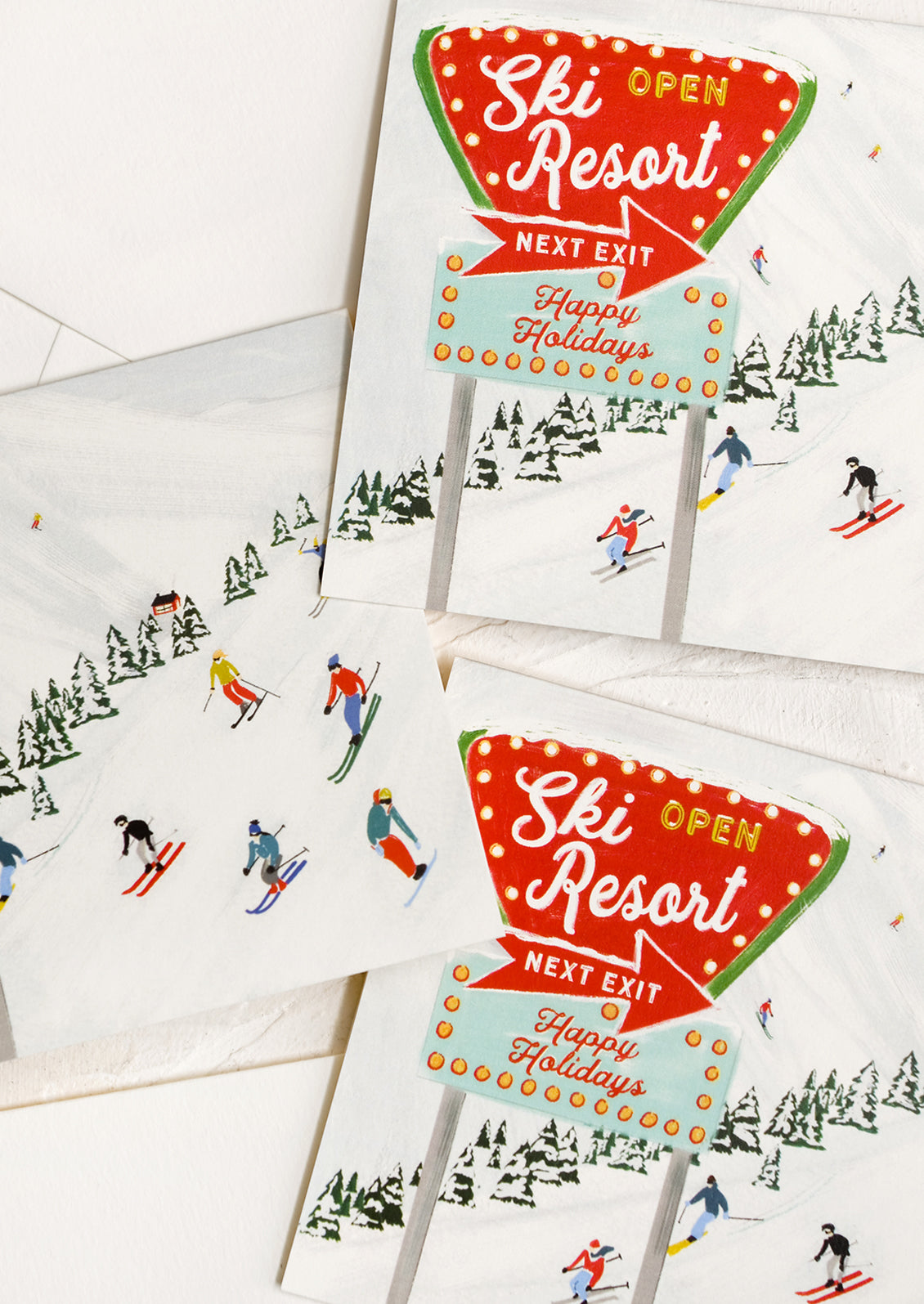 An illustrated greeting card with image of skiers on a hill.