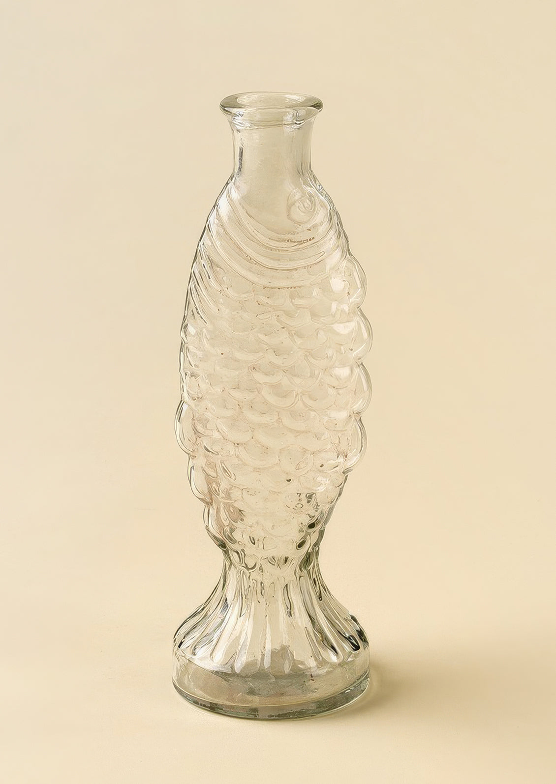 A glass vase/pitcher shaped like a fish.