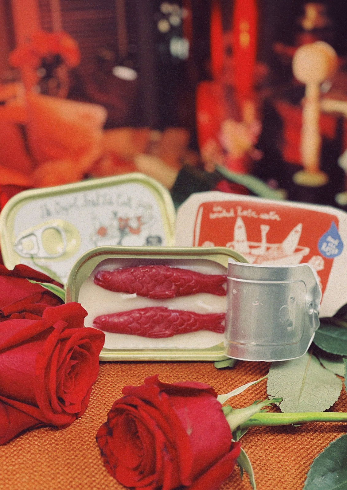 A tinned fish candle with red fish in rose water scent.