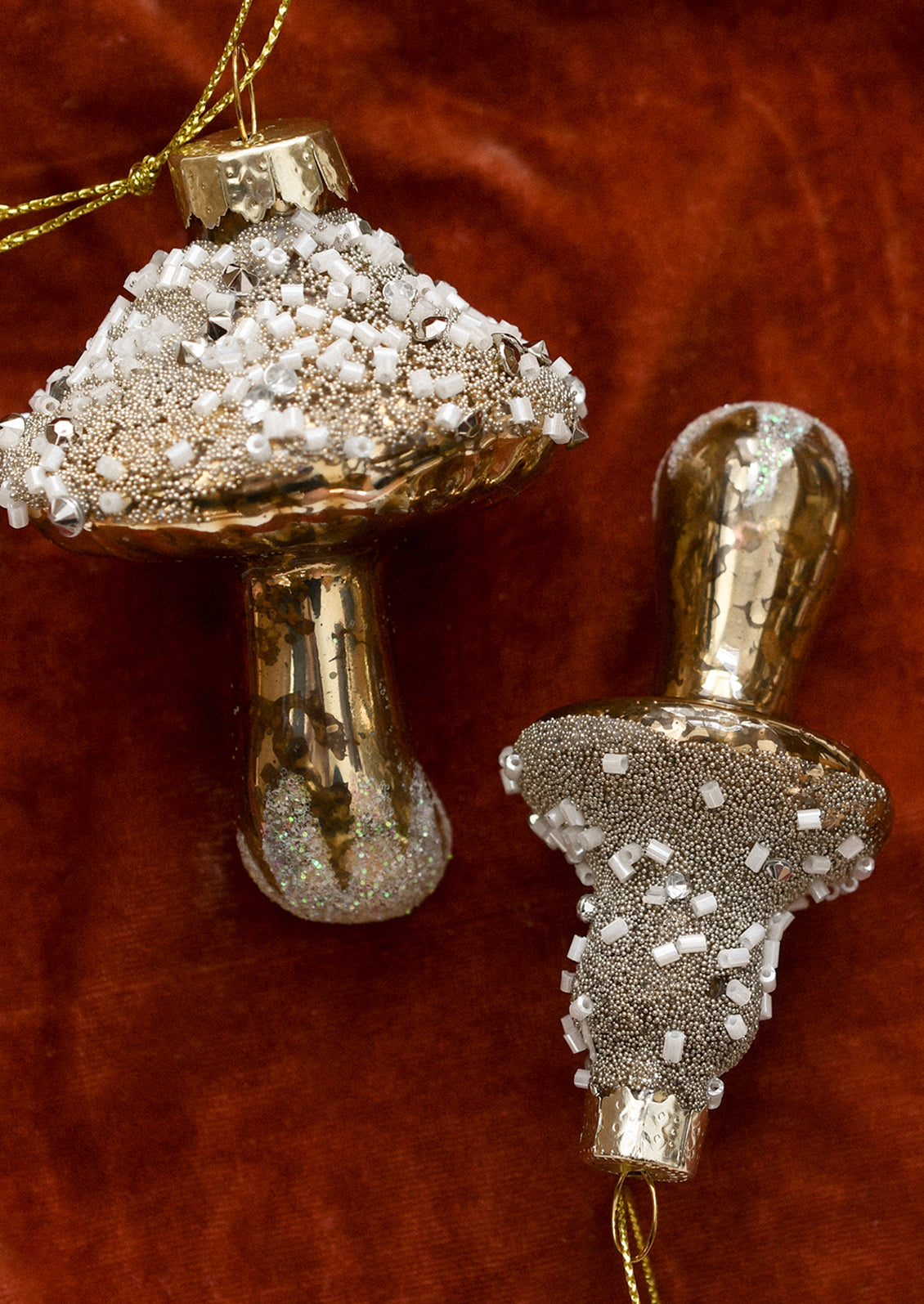 Glass ornaments of gold mushrooms with beaded "snow".