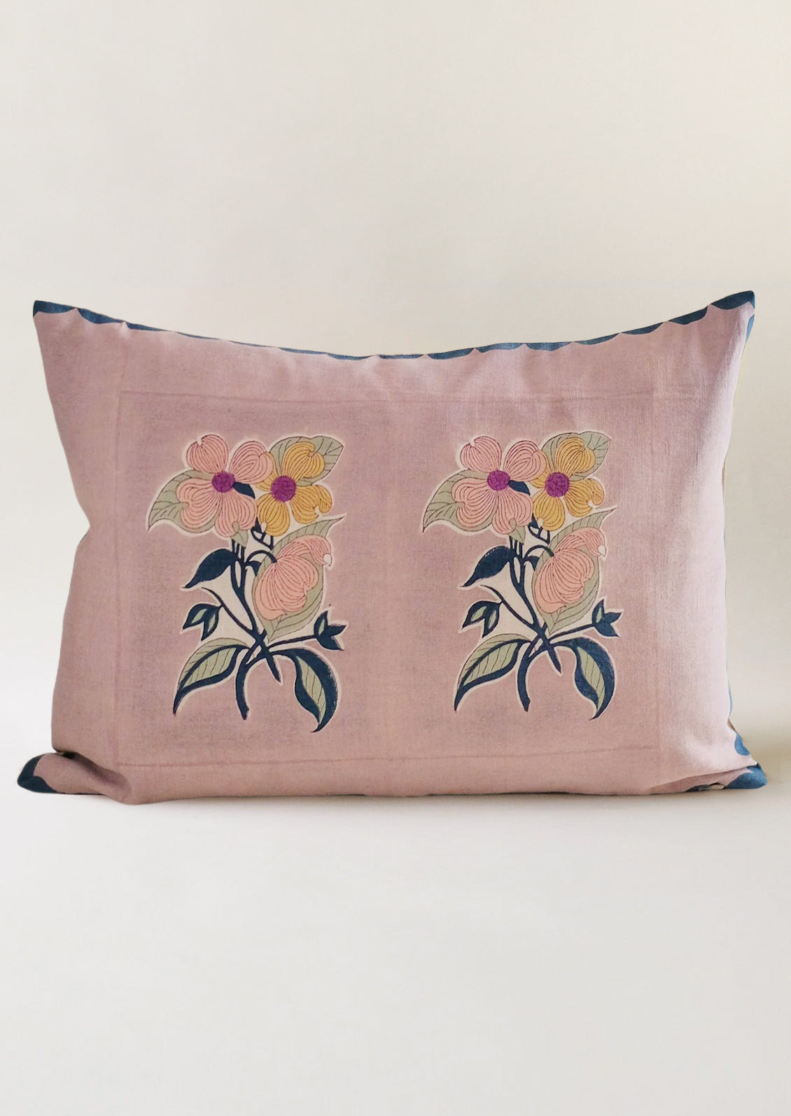 A throw pillow with lavender background and floral picture print.