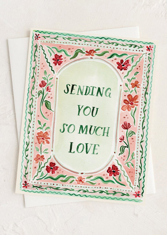Greeting card with floral border and text 'Sending you so much love' on a white background