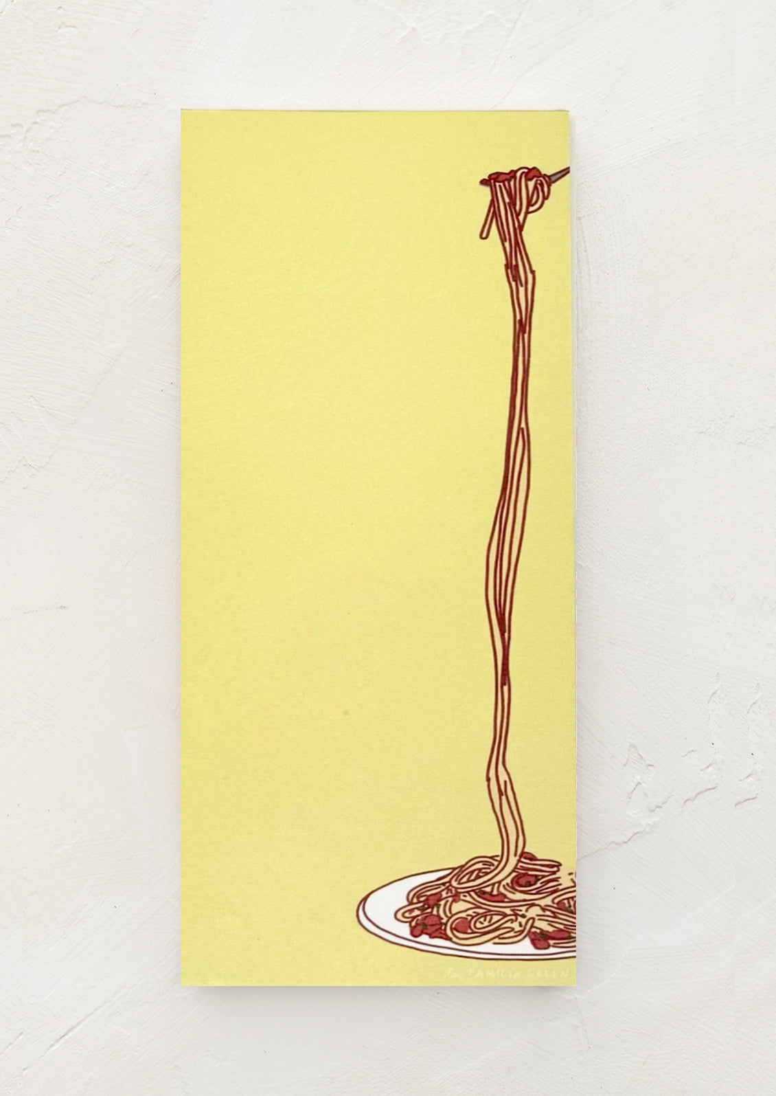 A lime green notepad with spaghetti print on side.