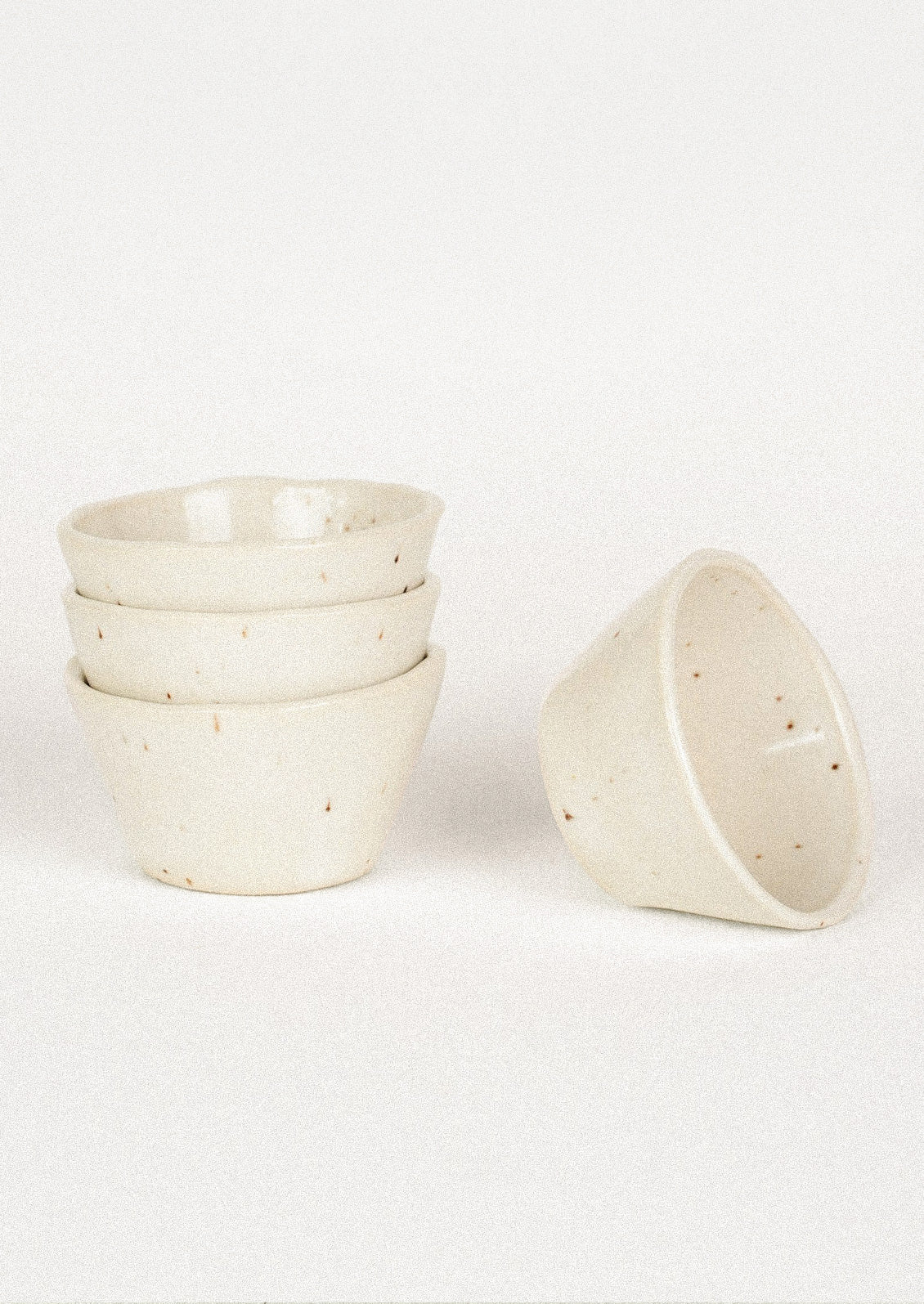 Small ceramic bowls in cream.