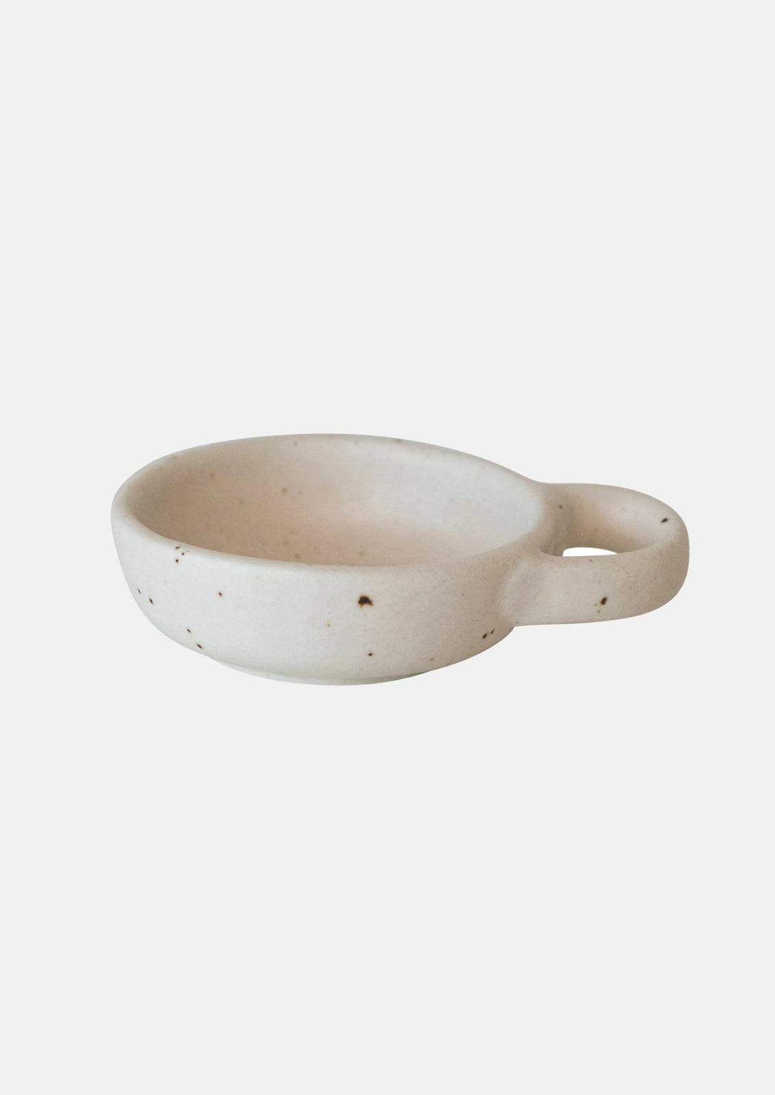 A small ceramic pinch bowl in speckled white ceramic with decorative handle.