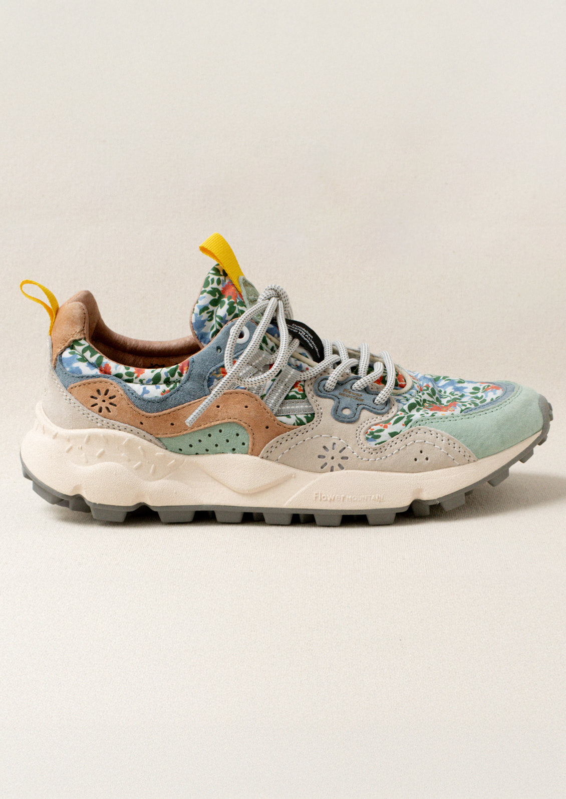 A pair of sneakers with floral print upper.