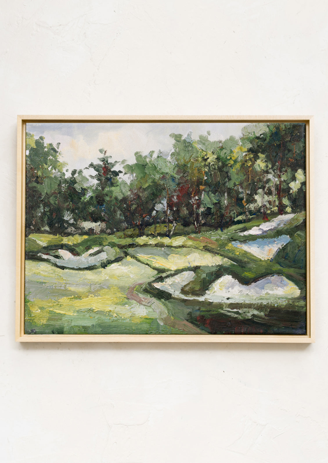 A framed original oil painting of a hilly countryside setting.