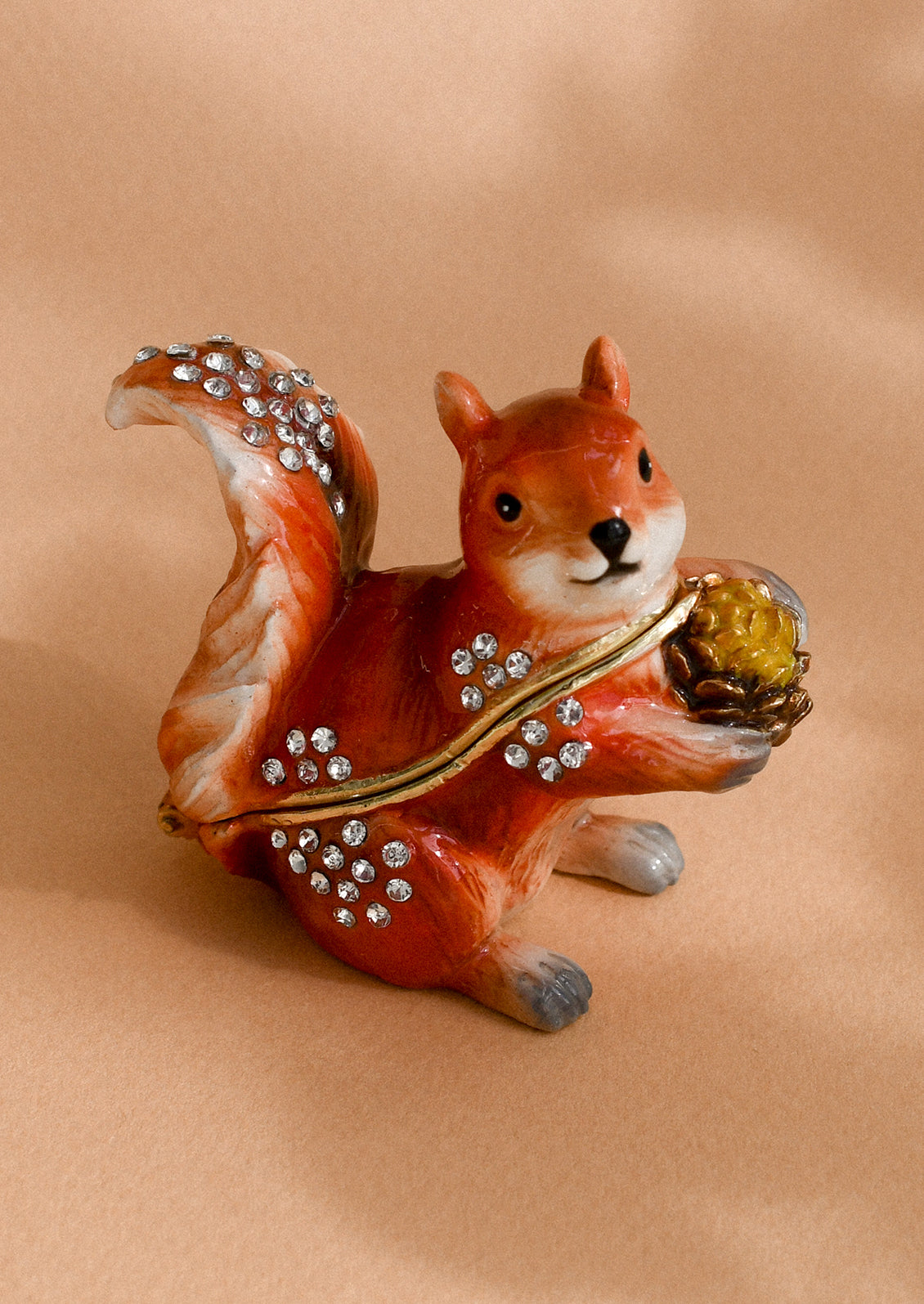 A crystal detailed metal trinket box depicting a red squirrel.