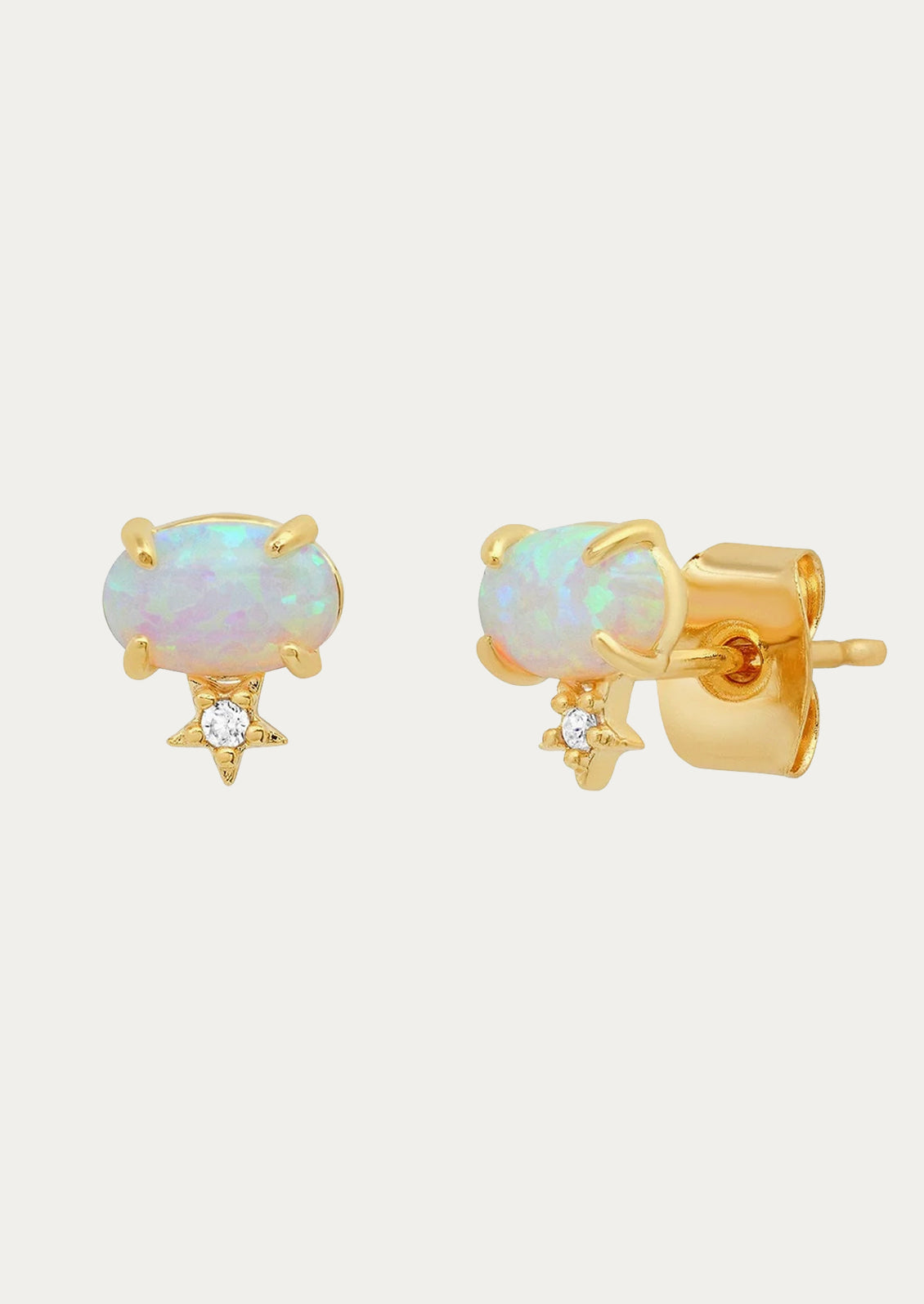 A pair of opal stud earrings with a star underneath.