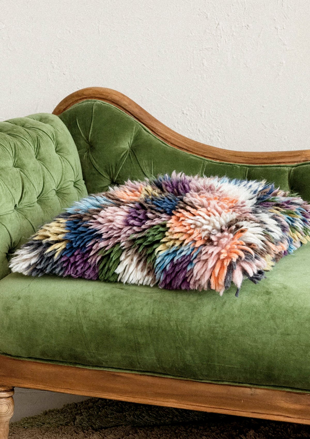 A throw pillow in multicolor wool shag.