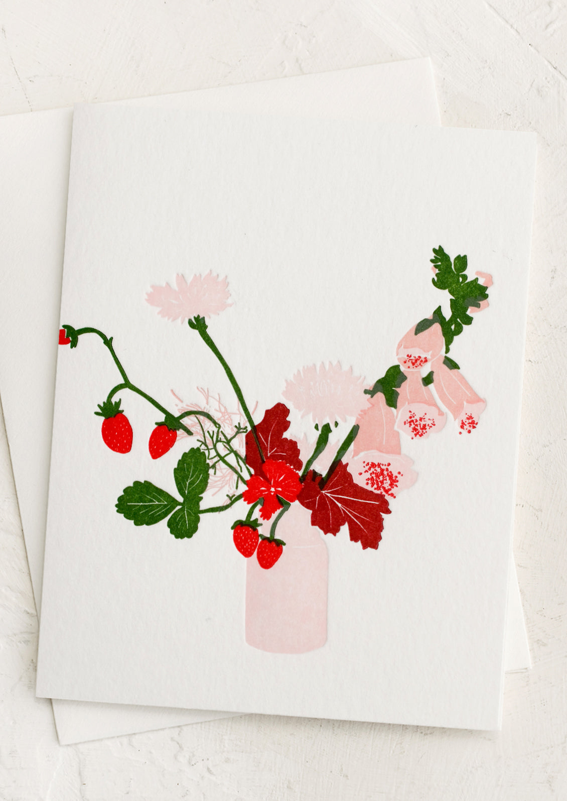 A letterpressed greeting card with image of pink floral arrangement in pink vase.
