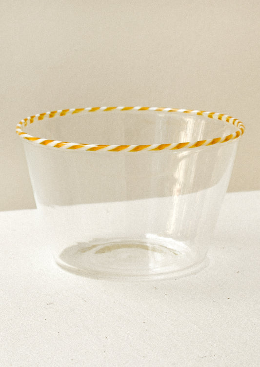 Clear glass blow with an orange striped rim
