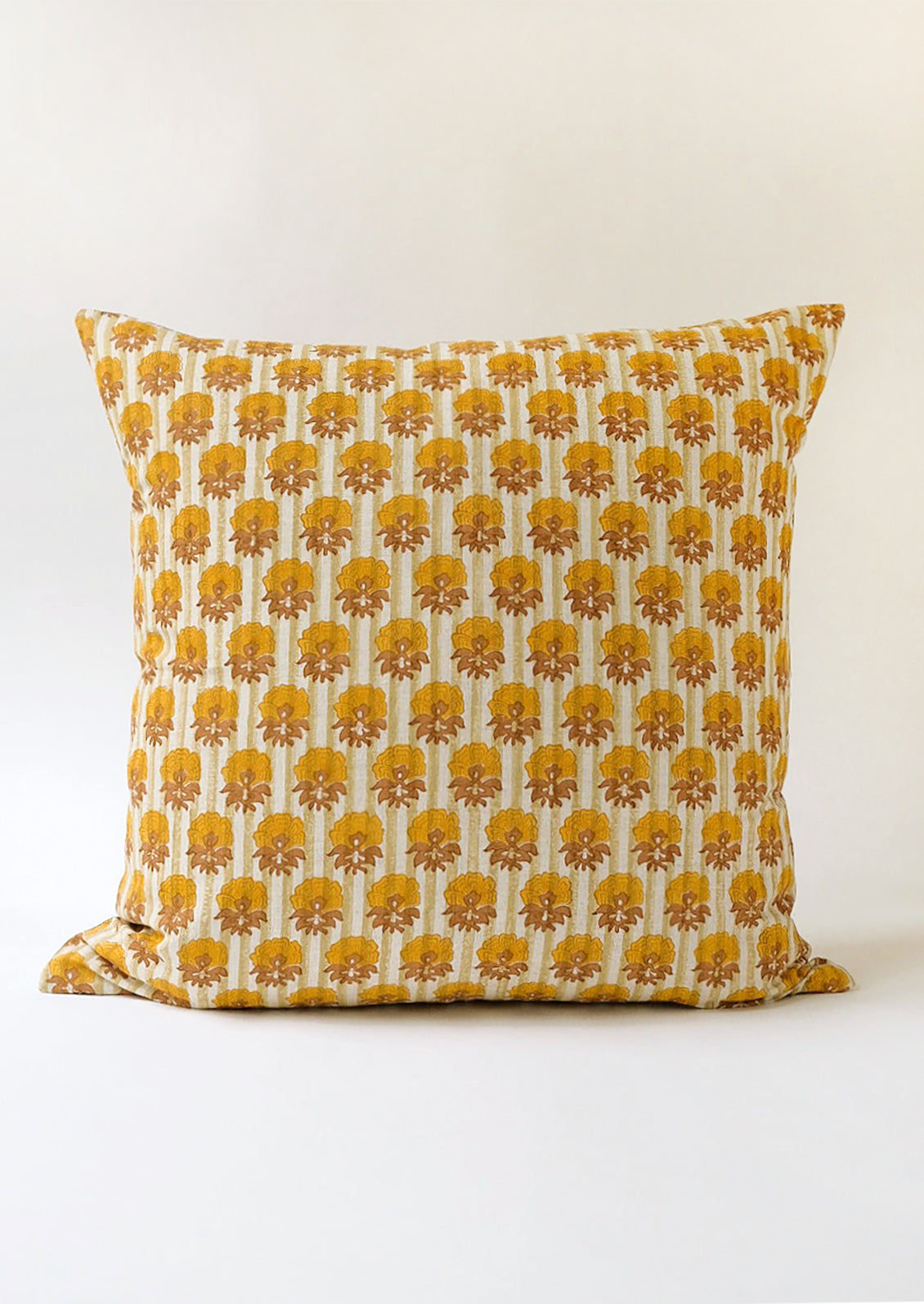 A striped block print pillow with floral print.