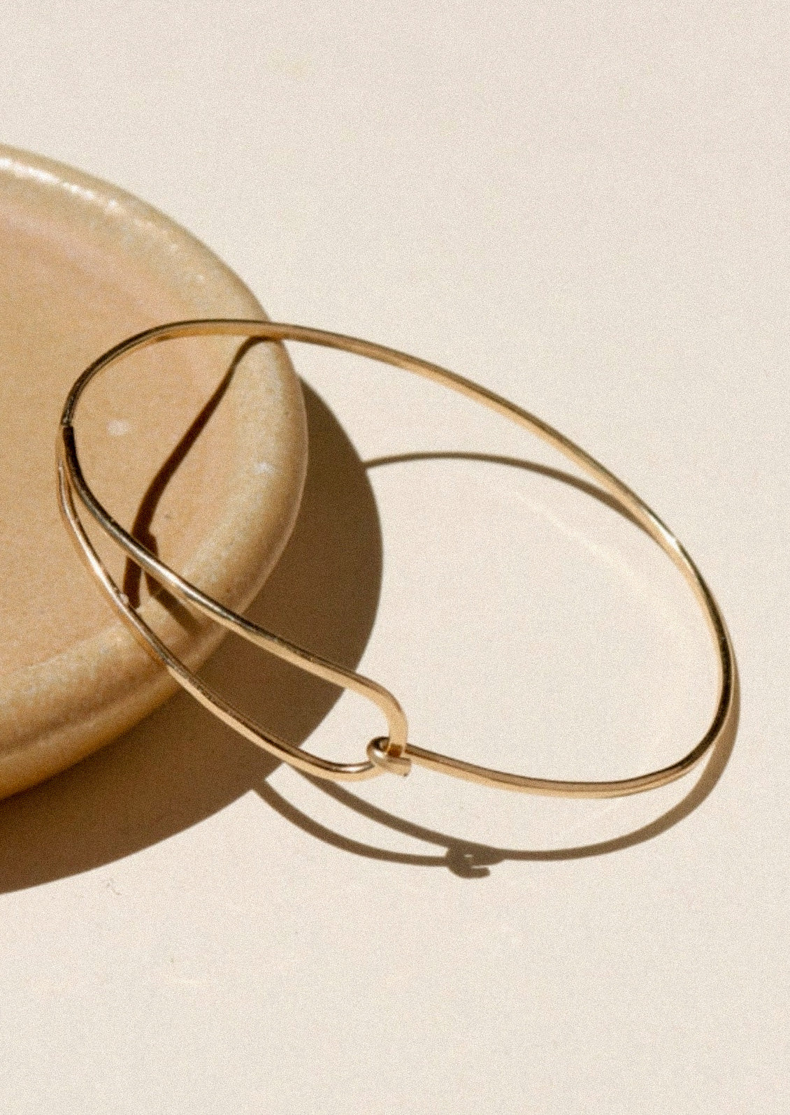 A minimal gold bracelet.