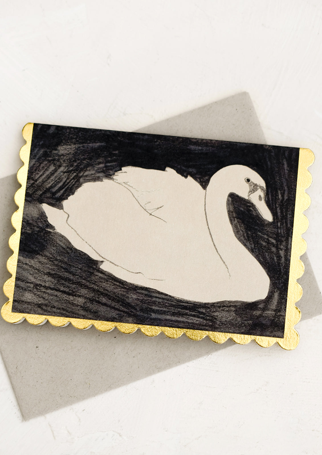 A scalloped edge greeting card with swan.
