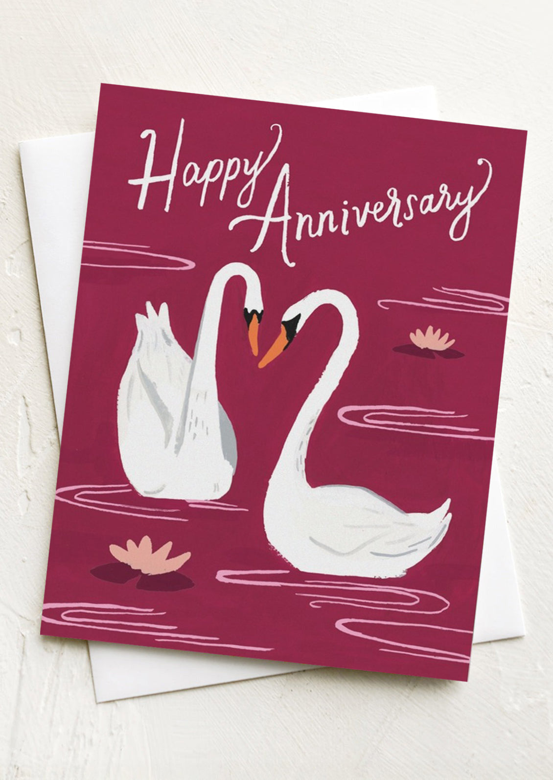 Greeting card with two swans and 'Happy Anniversary' text on a red background