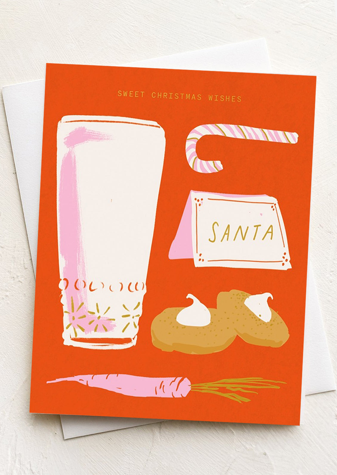 A greeting card with illustration of milk and cookies, text reads "sweet christmas wishes".