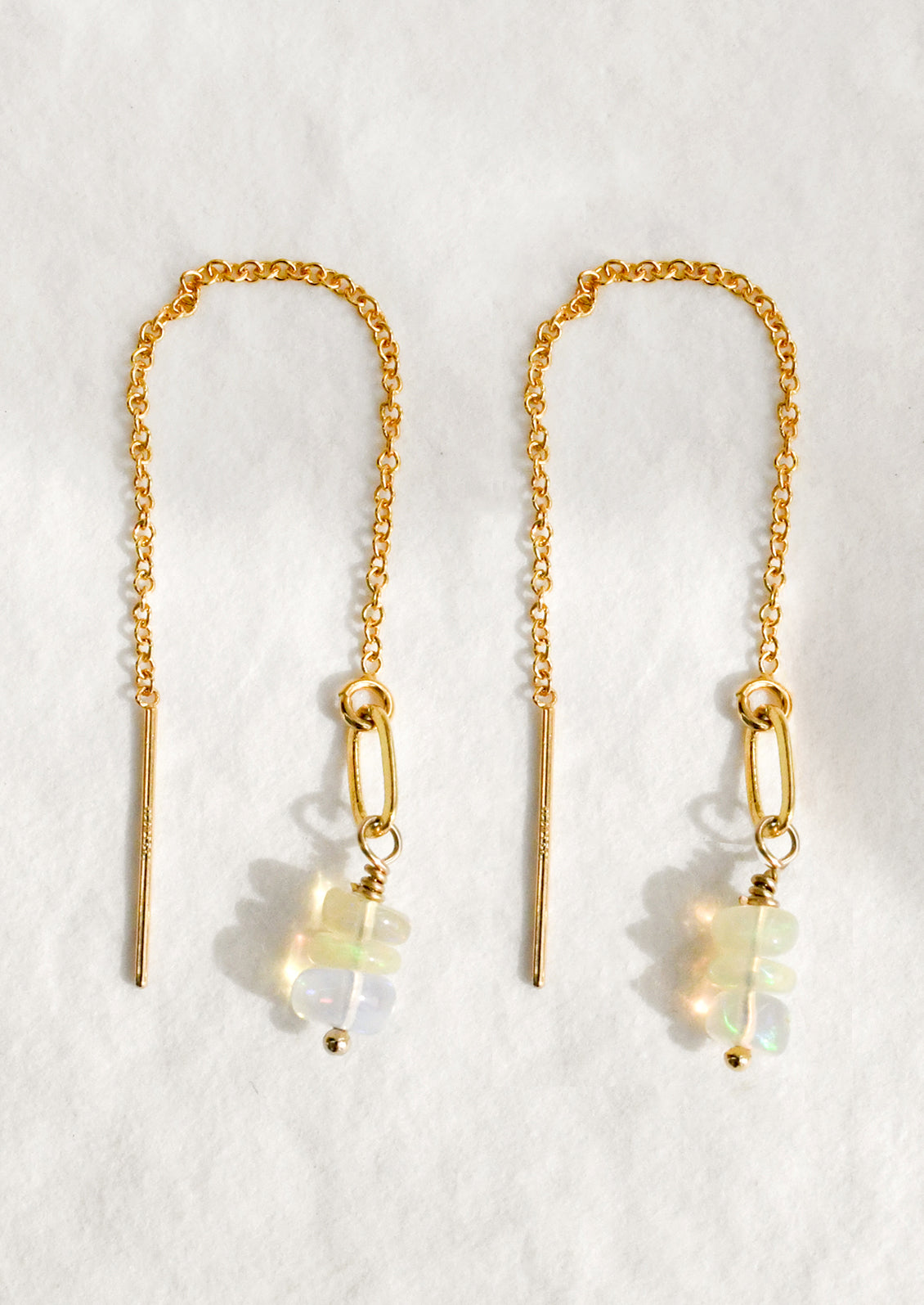A pair of gold delicate chain threader earrings with small Ethiopian opal stones