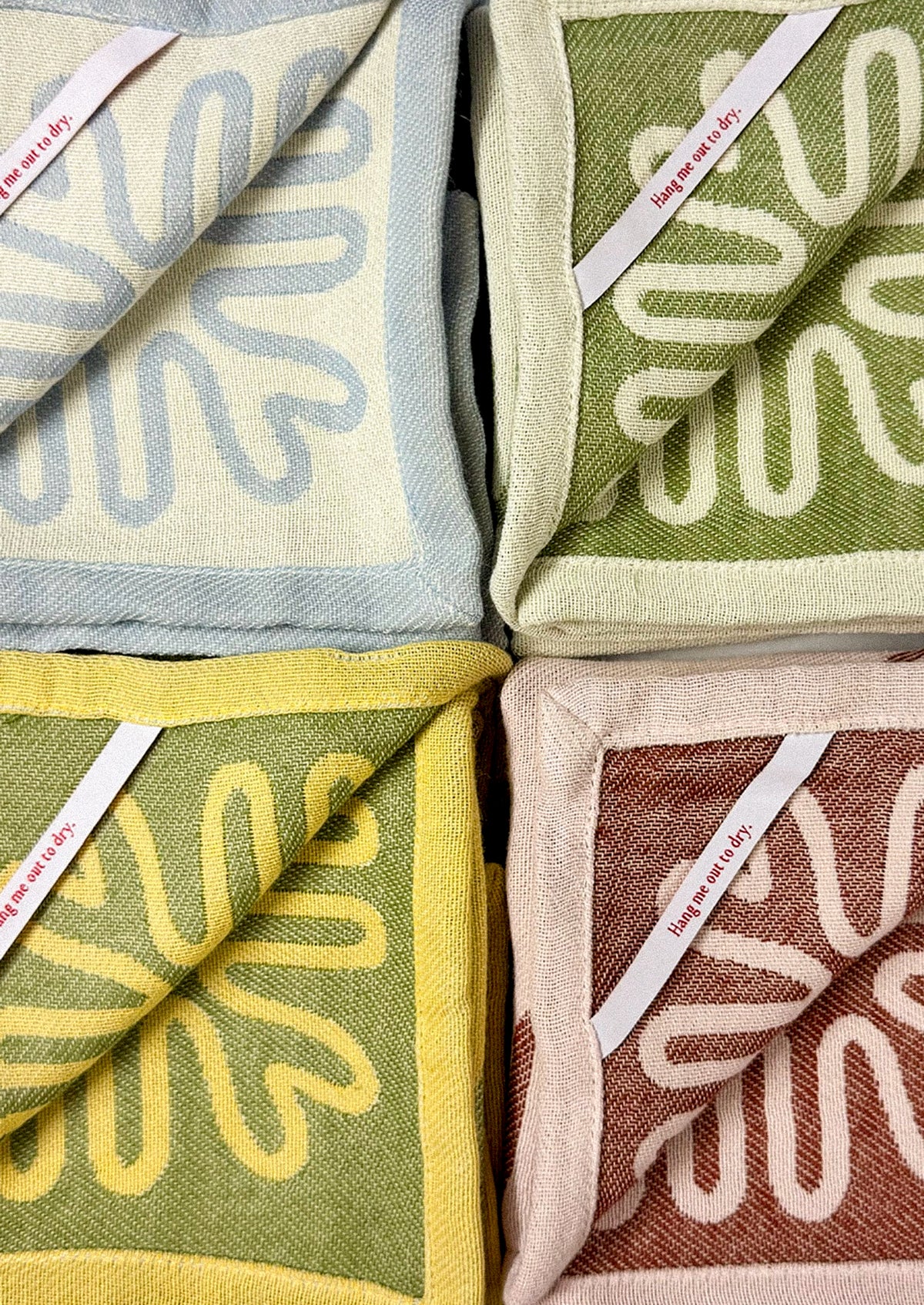 Dish towels with squiggle borders.