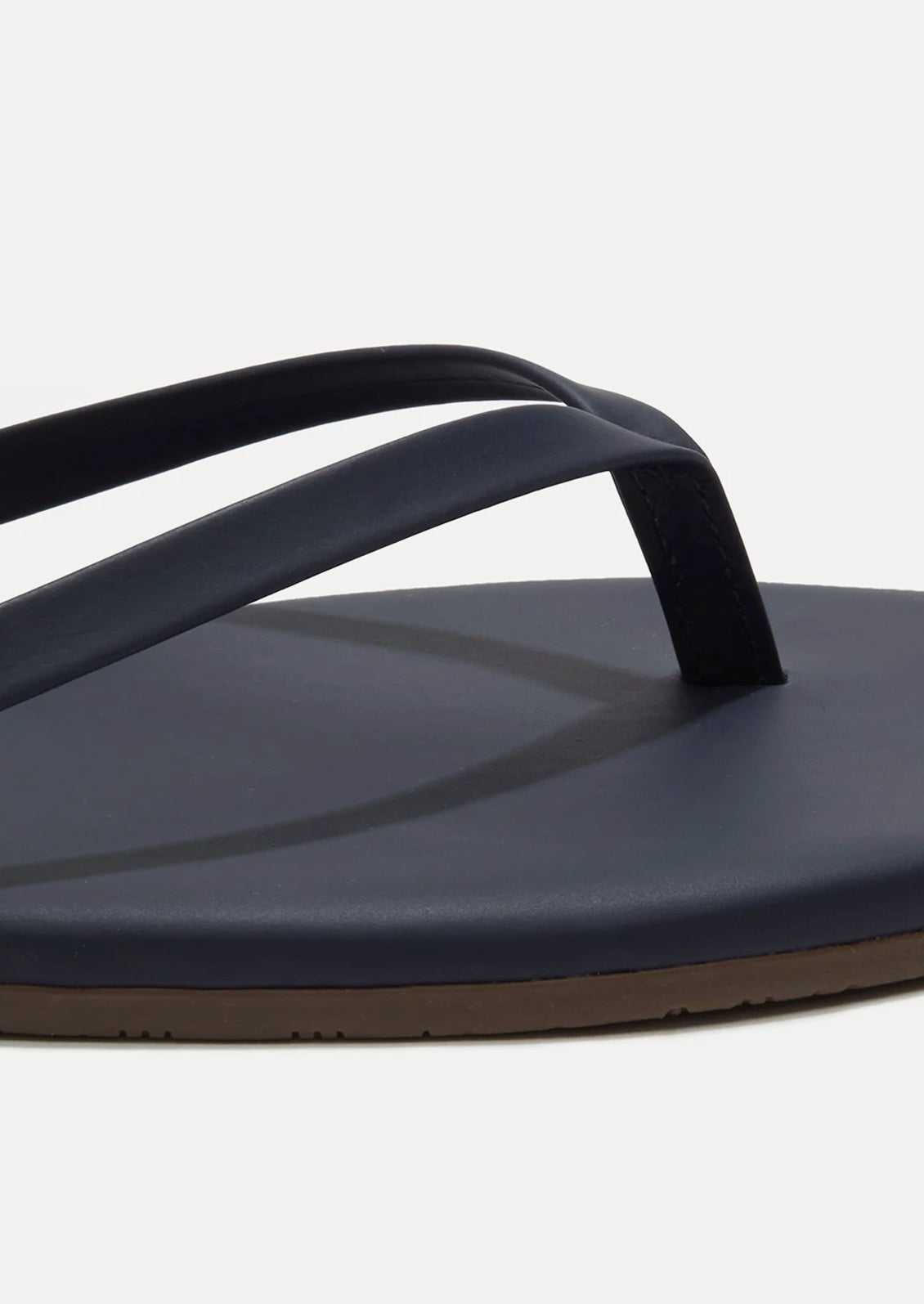 A leather skinny strap TKEES sandal in dark navy.