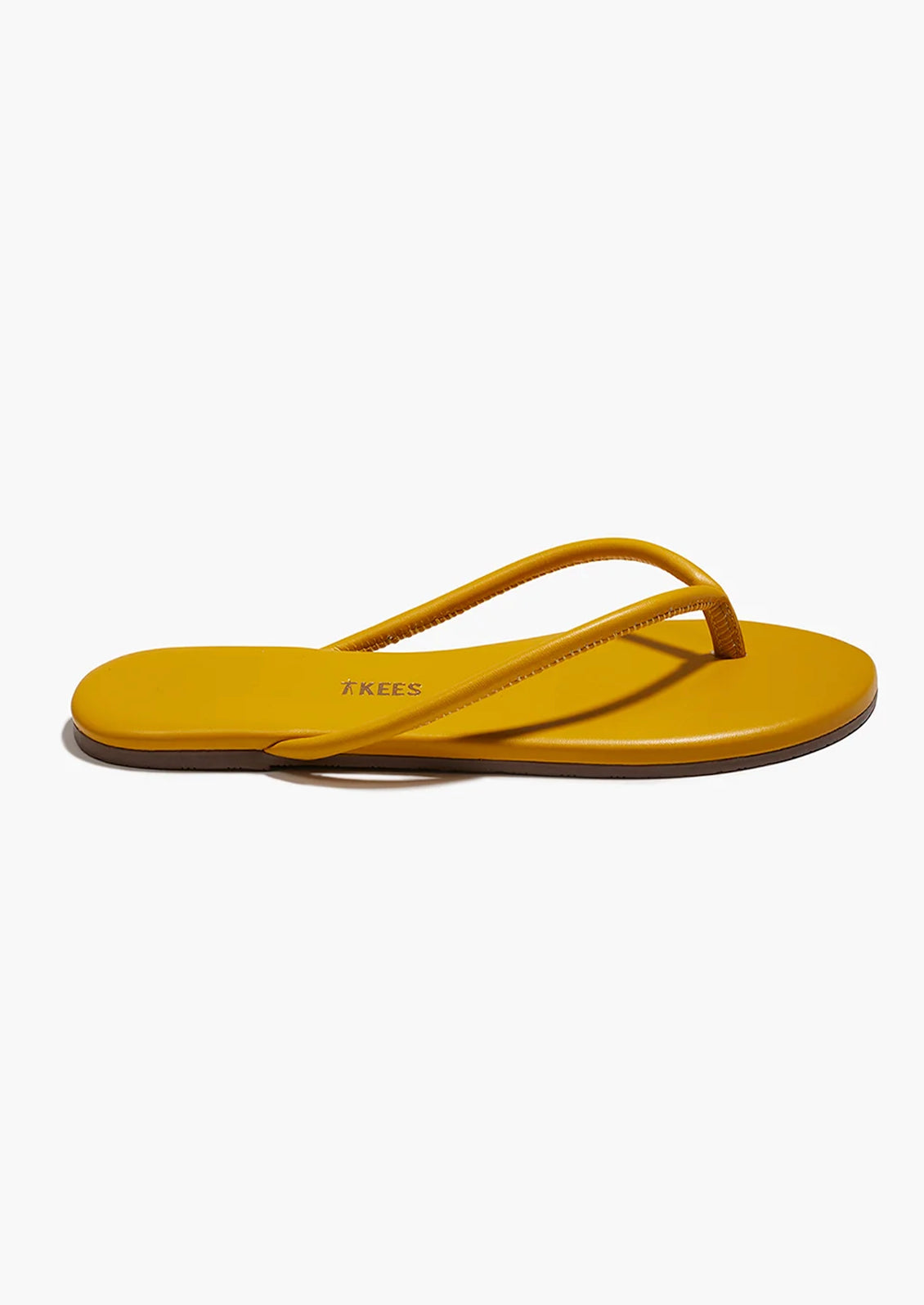 A leather TKEES sandal with a tubular strap design in deep yellow.