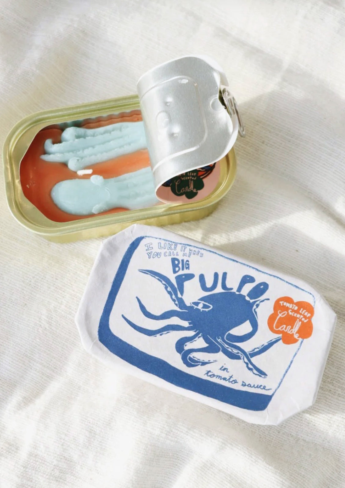 A tinned candle with octopus shape in tomato scent.