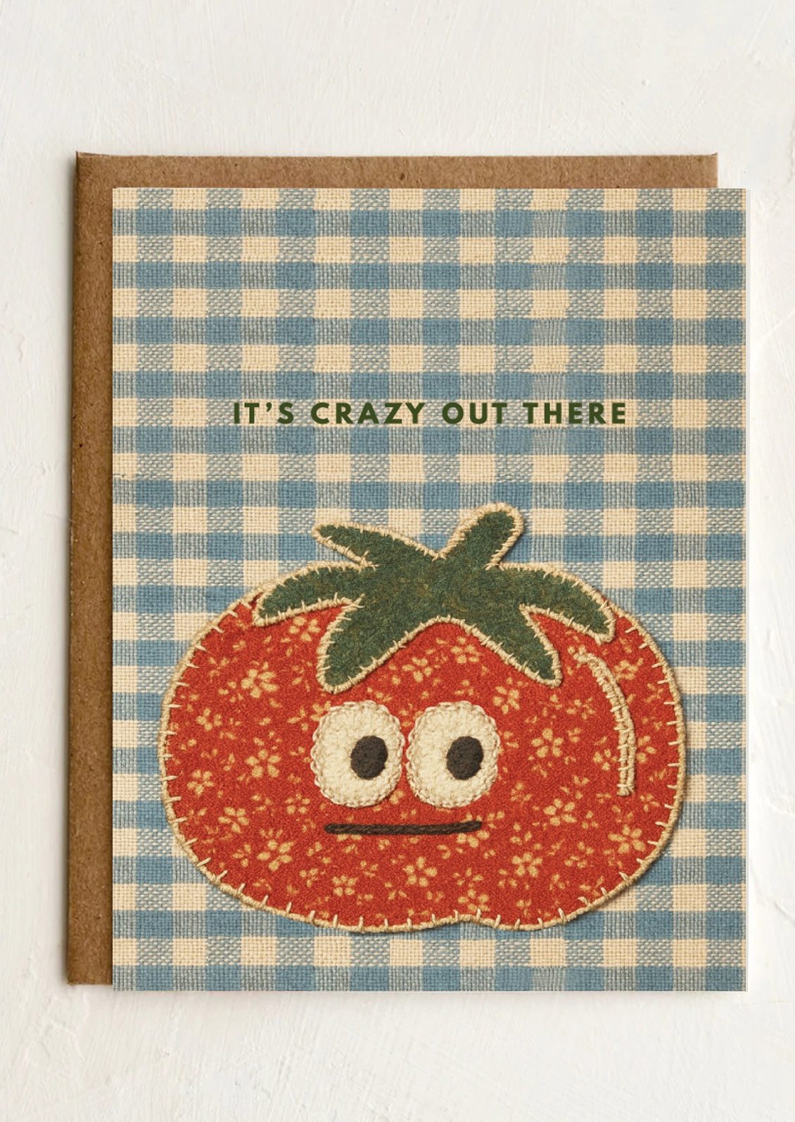 Card with a tomato illustration and text 'It's crazy out there' on a blue and white checkered background.