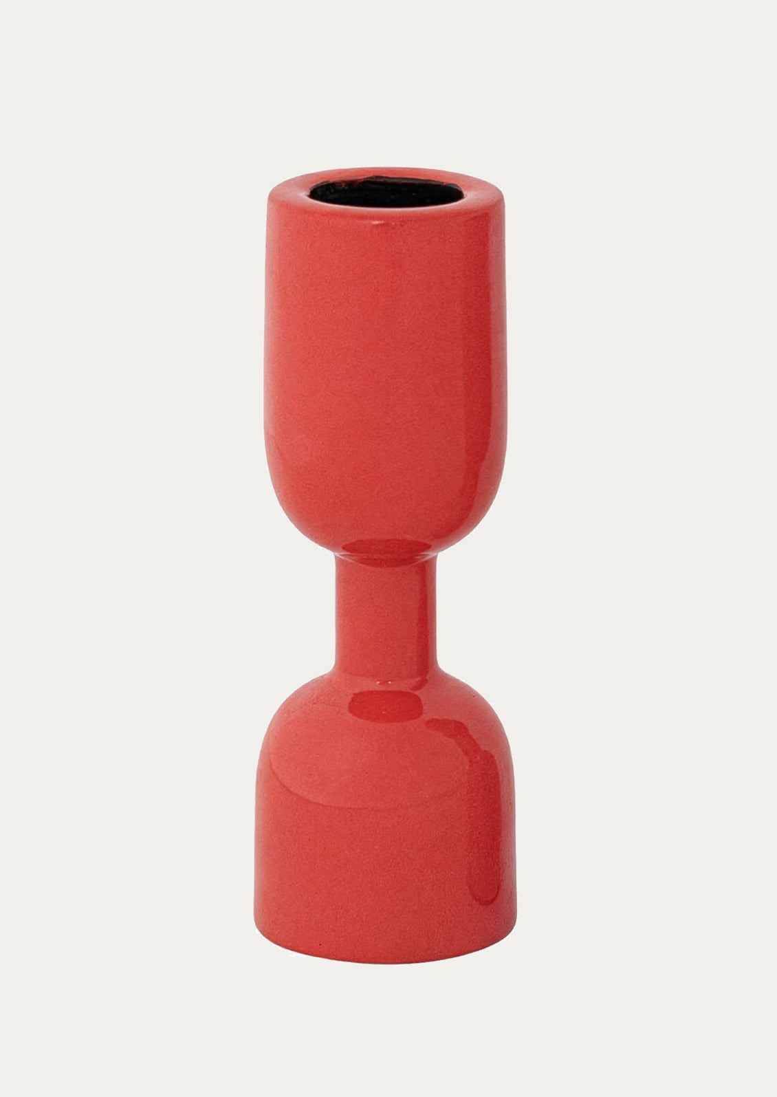 An enamel candle holder in red.