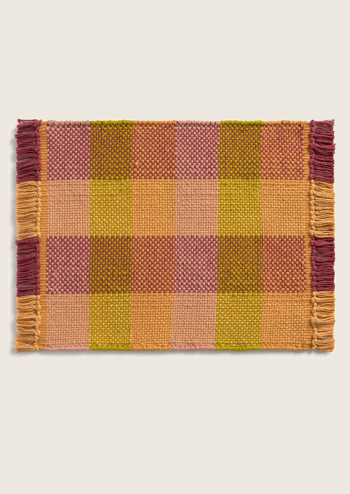 Plaid placemat with fringes on a white background
