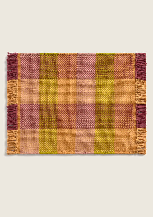 Plaid placemat with fringes on a white background