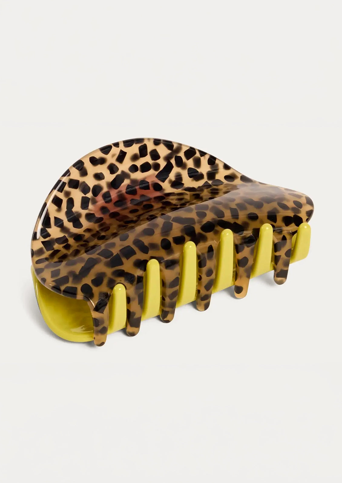 A two-tone hair claw with a chartreuse color on one side and a tortoise pattern on the other side.
