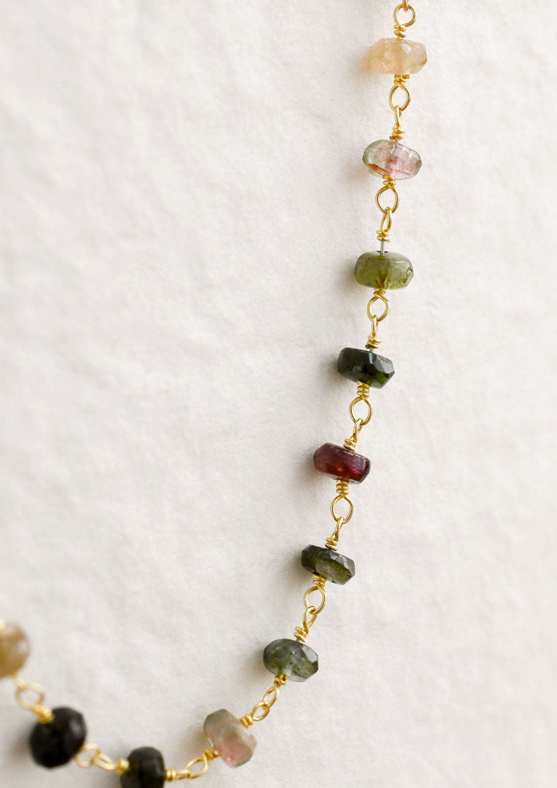 A paperclip chain necklace with tourmaline gemstone stations.