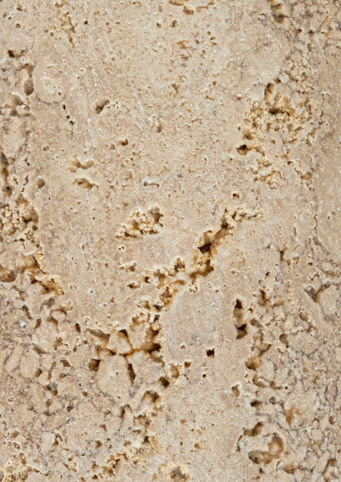 A pair of natural travertine bookends with wavy squiggle shape.