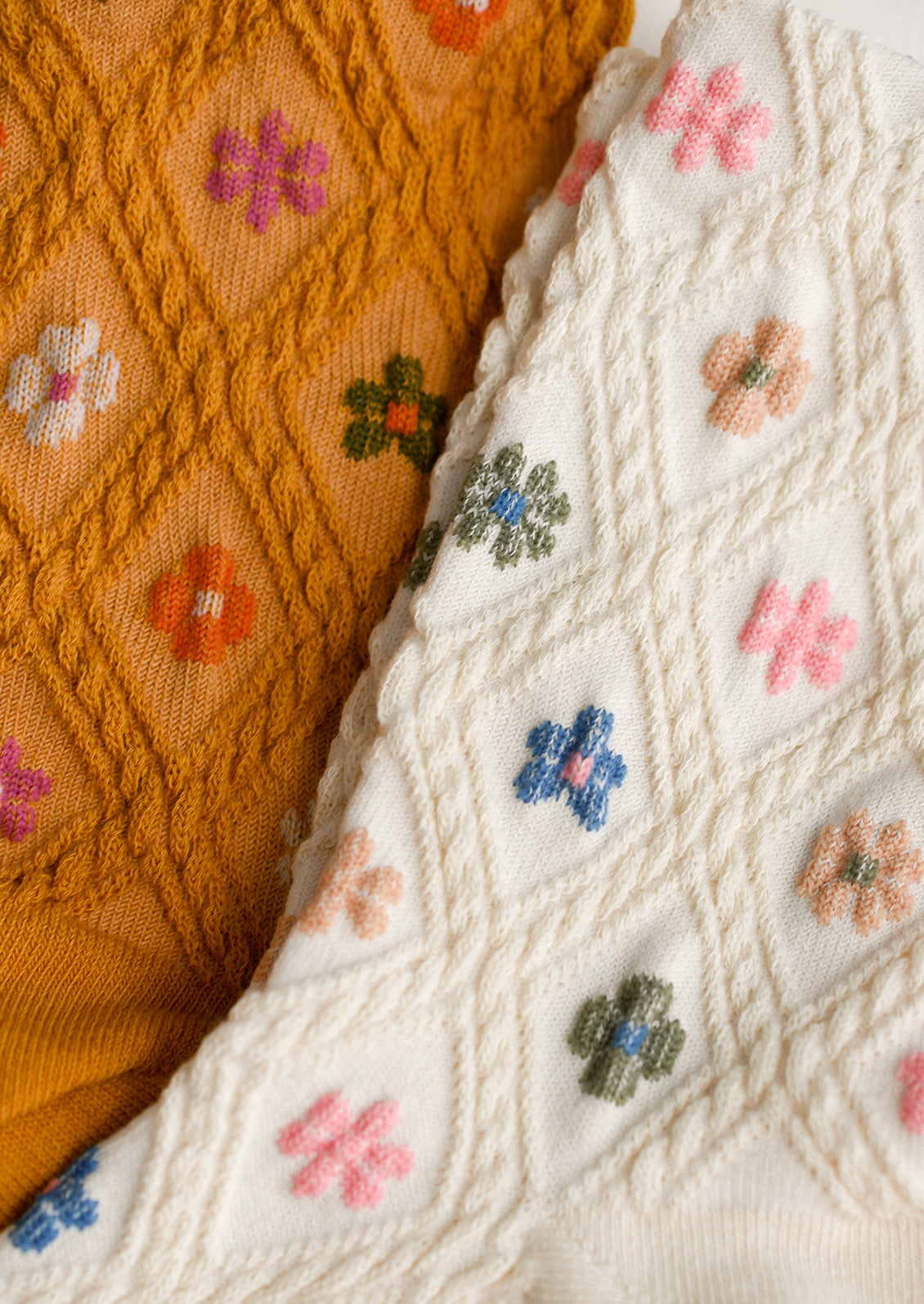 Socks with colorful floral pattern and raised diamond texture.