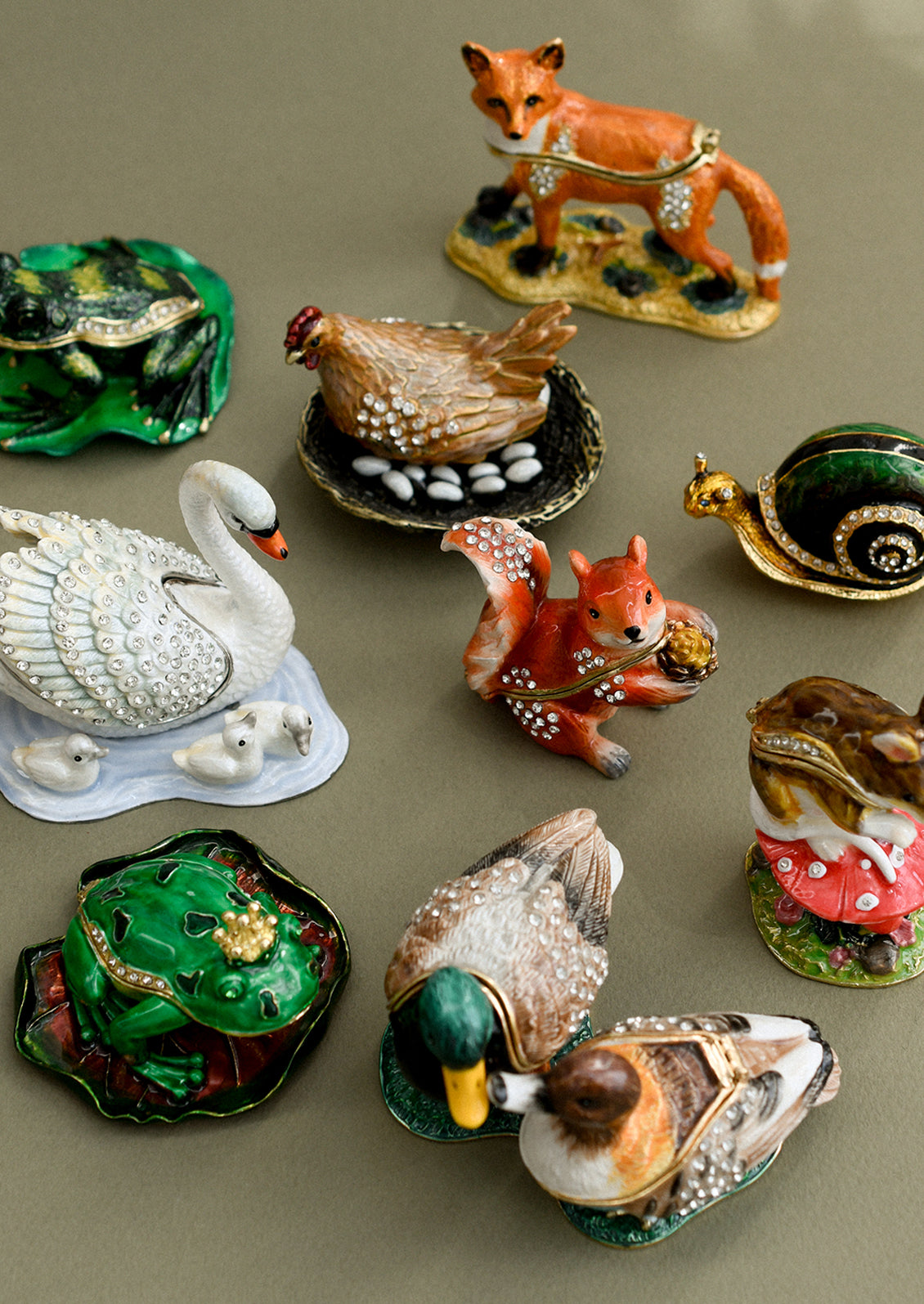 An assortment of crystal detailed metal trinket boxes in different animal styles.