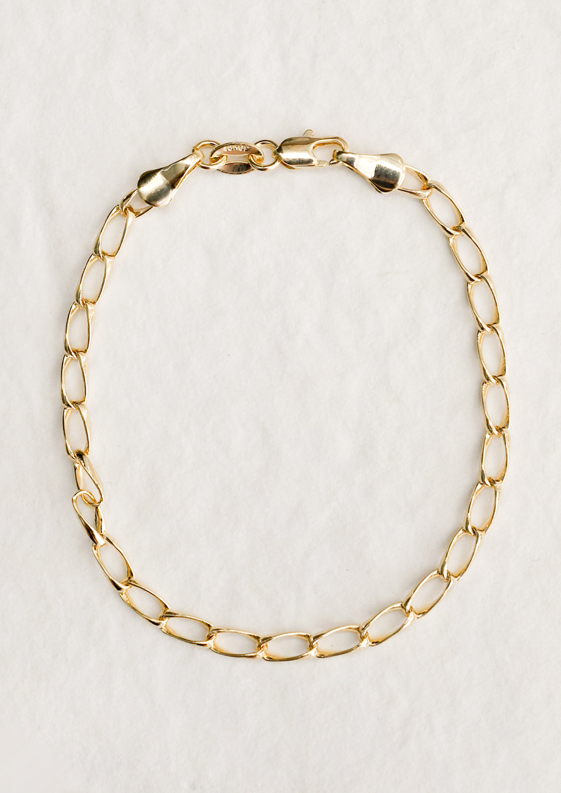 A gold bracelet with minimalist link chain.
