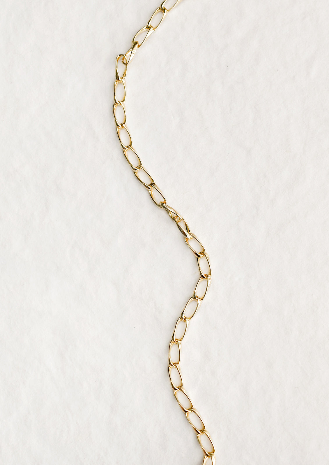 A gold bracelet with minimalist link chain.