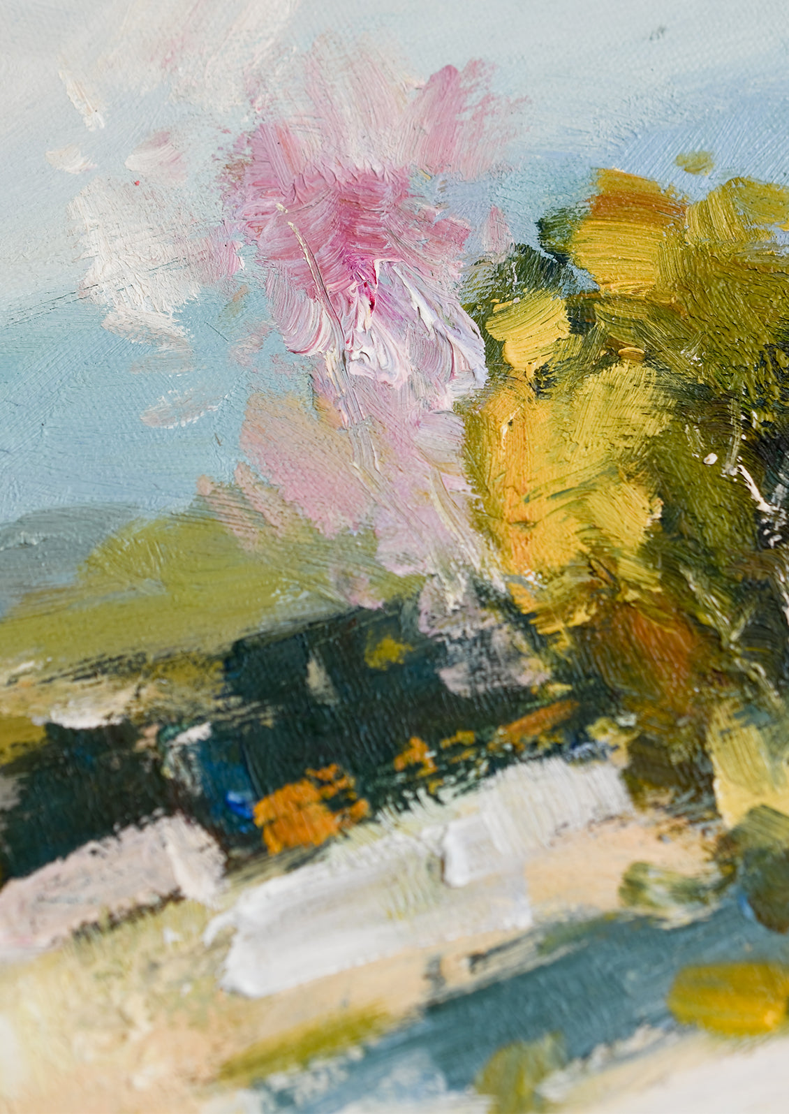 A framed original painting of colorful meadow/vista.